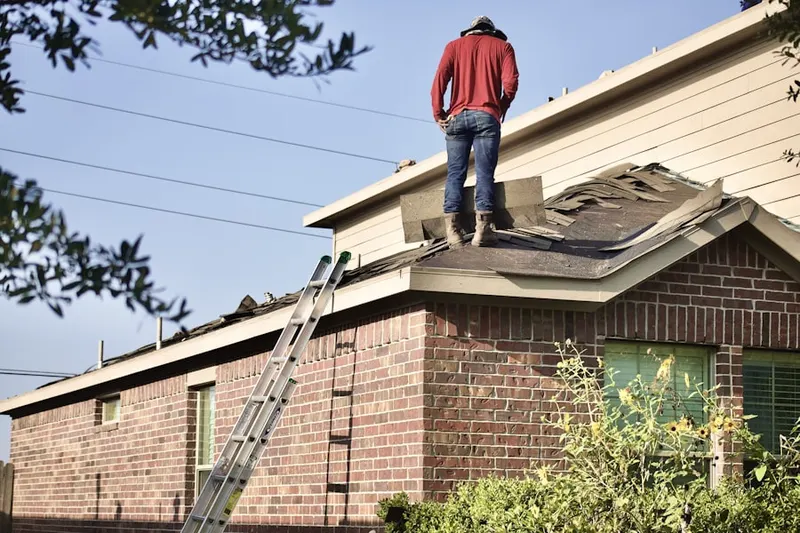 Professional roofer working on a residential roof in Mission Bend North